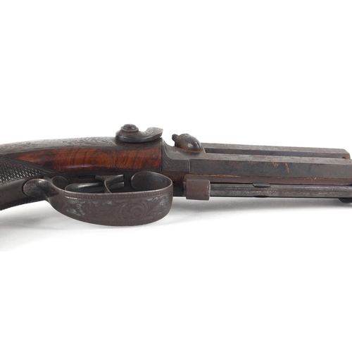 55 - Good early 19th century Irish walnut percussion over and under pistol by Kavanagh, with capacity in ... 