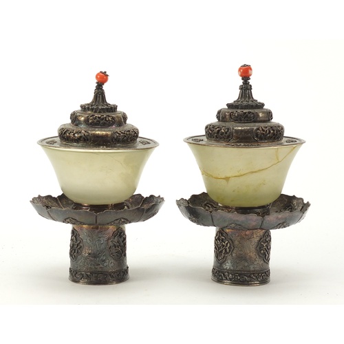 8 - Pair of Chinese green jade tea bowls with silver coloured metal stands and lids, each finely embosse... 