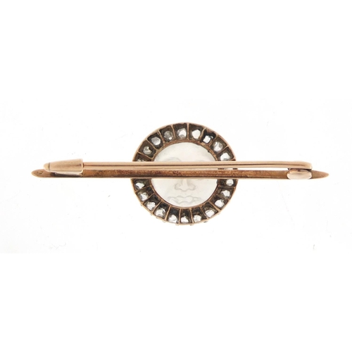 91 - Unmarked gold moonstone and diamond bar brooch, carved with a moon face, housed in a Collingwood Ltd... 