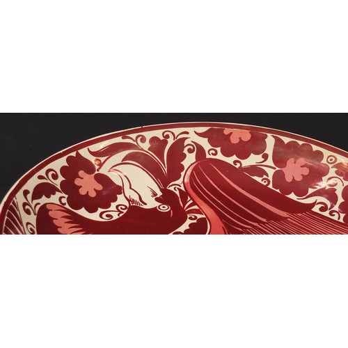 16 - Arts & Crafts ruby lustre charger by William de Morgan, hand painted with a stylised bird, impressed... 