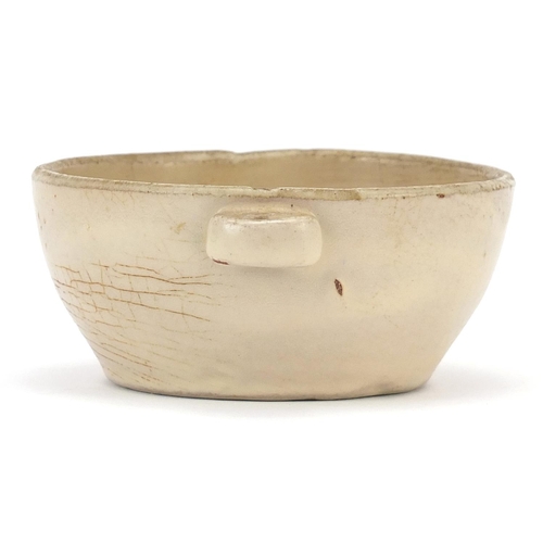 23 - Asian celadon glazed bowl with twin handles, possibly Korean or Chinese, 12.5cm wide