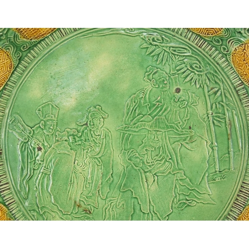 7 - Chinese green and yellow glazed porcelain dish decorated in relief with figures in a palace setting,... 