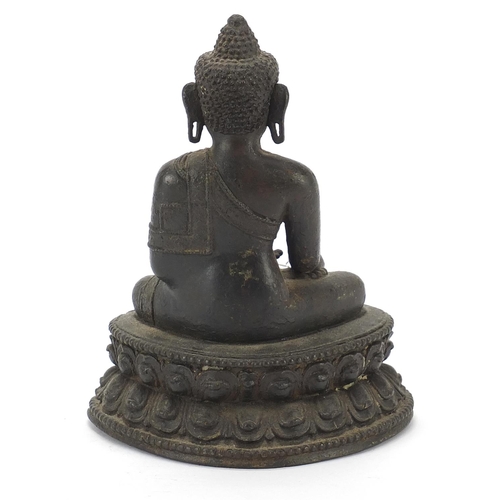 114 - Chino Tibetan patinated bronze figure of seated Buddha, character marks to the interior, 16.5cm high