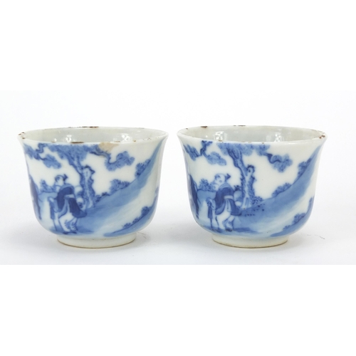 12 - Pair of Chinese blue and white porcelain tea bowls, each hand painted with a figure on buffalo back ... 