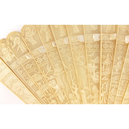 36 - Chinese Canton ivory brise fan carved with figures amongst pagodas and in boats, 18cm in length when... 