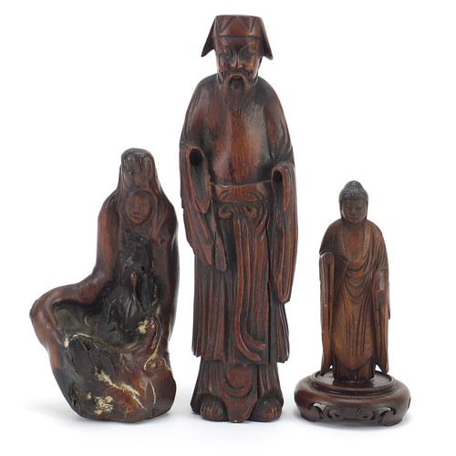 53 - Three Chinese wood carvings including one of an elder and one of standing Buddha, the largest 19.5cm... 