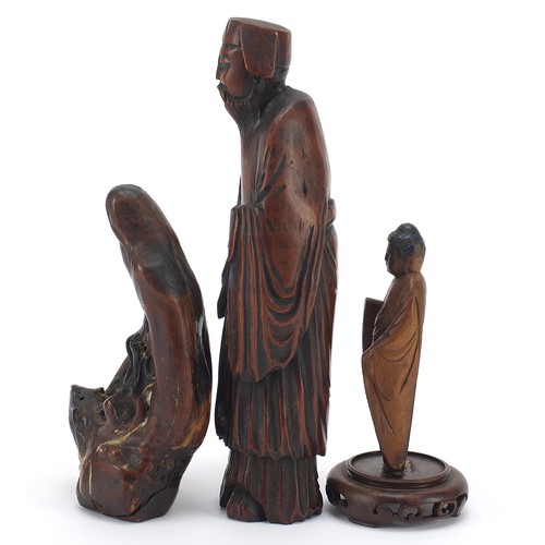 53 - Three Chinese wood carvings including one of an elder and one of standing Buddha, the largest 19.5cm... 