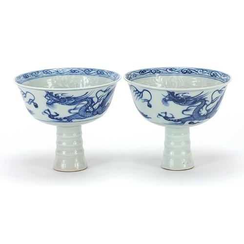81 - Pair of Chinese blue and white stem cup with dragons, 12cm in diameter