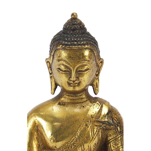 25 - Chino Tibetan gilt bronze figure of seated buddha, 13cm high