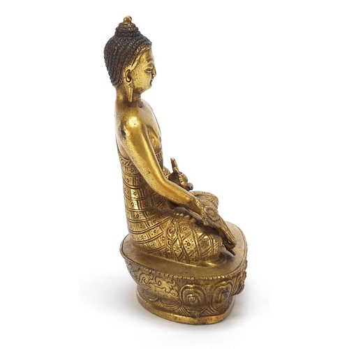 25 - Chino Tibetan gilt bronze figure of seated buddha, 13cm high