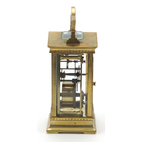 91 - French brass cased carriage clock with enamelled dial having Roman numerals, 13cm high excluding the... 