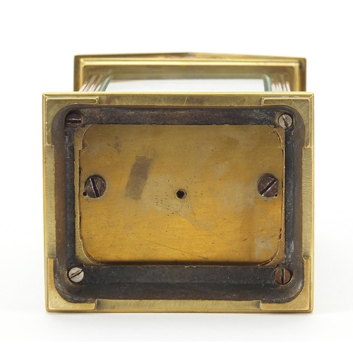 91 - French brass cased carriage clock with enamelled dial having Roman numerals, 13cm high excluding the... 