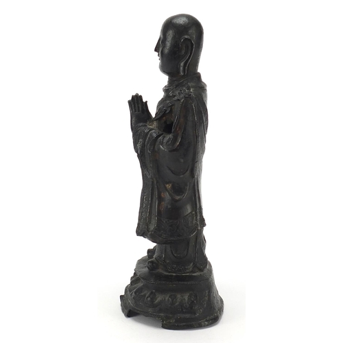 7 - Chinese patinated bronze figure of a standing monk, 24.5cm high