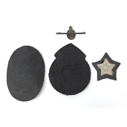 1442A - Militaria to include civil defence uniforms with black buttons, silver and enamel brooch and cloth p... 