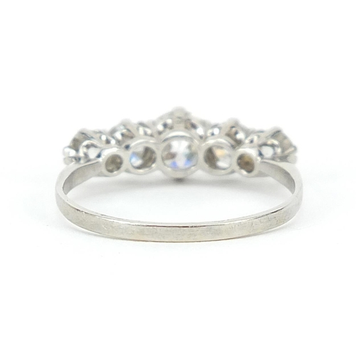 1596 - Unmarked white metal graduated diamond five stone ring, the central diamond approximately 4.5mm in d... 