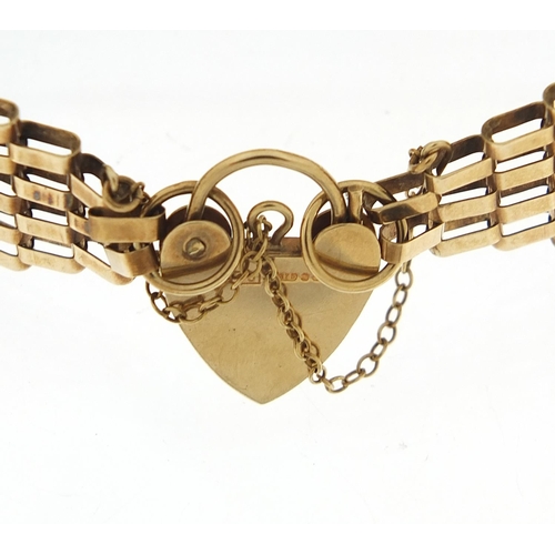 1598 - 9ct gold seven row gate link bracelet with love heart padlock, 17cm in length, 14.4g