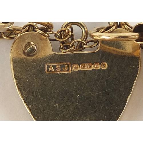 1598 - 9ct gold seven row gate link bracelet with love heart padlock, 17cm in length, 14.4g