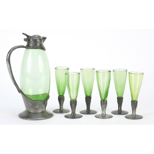 17 - Archibald Knox for Liberty & Co, Arts & Crafts pewter and green glass liqueur set comprising jug and... 