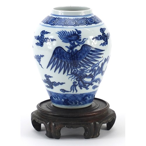 16 - Chinese blue and white porcelain vase hand painted with phoenixes raised on carved hardwood stand, t... 
