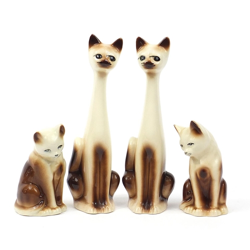 Two pairs of porcelain seated cats, the largest 36cm high