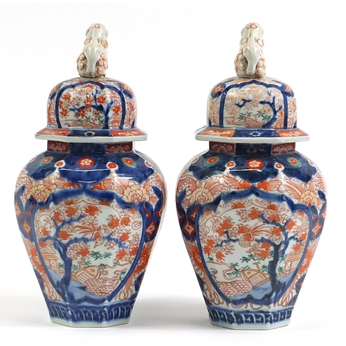 46 - Pair of Japanese Imari porcelain vases and covers hand painted with flower, 32cm high