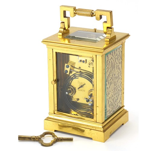 26 - French brass cased repeating carriage clock with fret panels and enamelled dial, the backplate and k... 