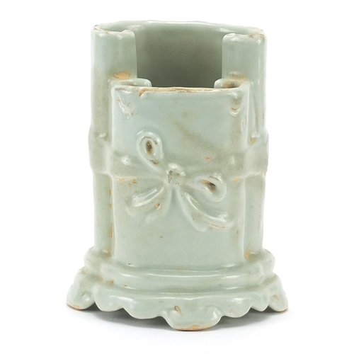 33 - Chinese porcelain brush pot in the form of two scrolls having a celadon glaze, 10cm high