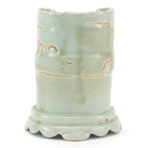 33 - Chinese porcelain brush pot in the form of two scrolls having a celadon glaze, 10cm high