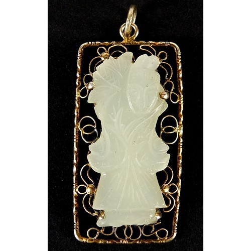 408 - Chinese silver gilt pendant housing a pale green jade panel carved with a figure, 4cm high, 8.2g