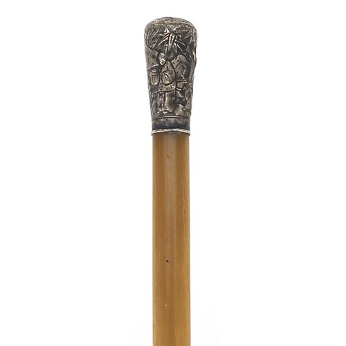 38 - Chinese rhinoceros horn stick with unmarked silver pommel embossed with figures, 53cm in length