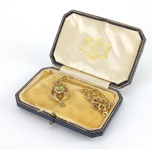 851 - Art Nouveau 9ct gold peridot and seed pearl pendant on a 18ct gold necklace housed in a Le Roy et Fi... 