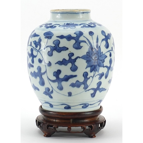 4 - Chinese blue and white porcelain vase hand painted with flowers amongst foliage, raised on carved ha... 