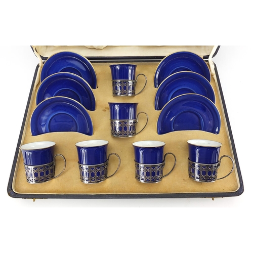 11 - Set of six Shelley blue ground coffee cans and saucers with silver cup holders housed in a fitted si... 
