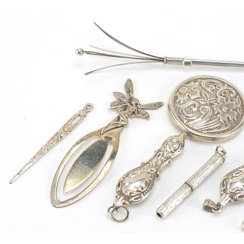 52 - Silver objects including propelling swizzle stick, magnifying glass and button hook, the largest 10c... 