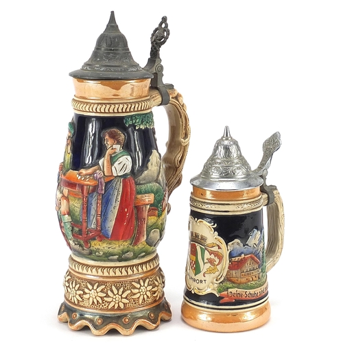 59 - Two German pottery beer steins including a musical example decorated in relief with merry figures, t... 
