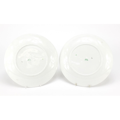 57 - Pair of Art Deco porcelain plates with hand painted motifs, each 23cm in diameter