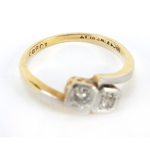 45 - 18ct gold and platinum diamond two stone crossover ring housed in a Spikins Wimbledon box, size L, 2... 
