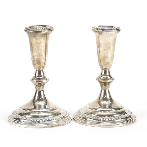 Pair of sterling silver weighted candlesticks, 14cm high, 775.0g