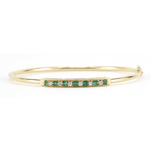 40 - 14ct gold emerald and diamond bangle, 6.3cm in diameter, 5.5g
