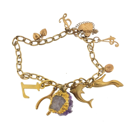 52 - 9ct gold charm bracelet with a selection of 9ct gold charms, unmarked gold charms and an amethyst sp... 