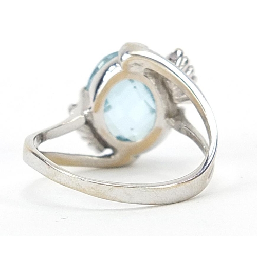 13 - 18ct white gold blue stone and diamond crossover ring, possibly aquamarine, size N, 5.2g