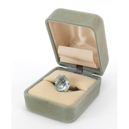 13 - 18ct white gold blue stone and diamond crossover ring, possibly aquamarine, size N, 5.2g