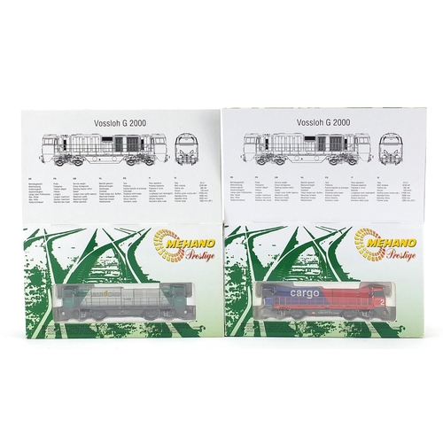 Two Mehano Vossloh G2000 N gauge model railway locomotives with boxes comprising SBB Cargo 55536 and Rail 4 Chem 55878