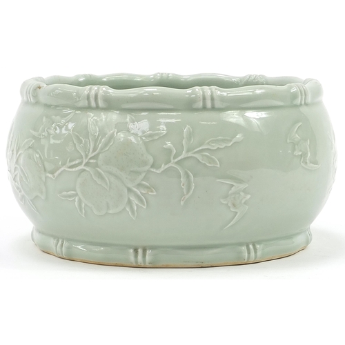 11 - Good Chinese porcelain bowl having a celadon glaze decorated in low relief under glaze with peaches,... 