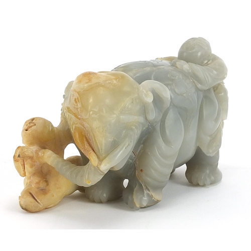Chinese pale green and russet hardstone carving of two boys and an elephant, possibly jade, 15cm in length