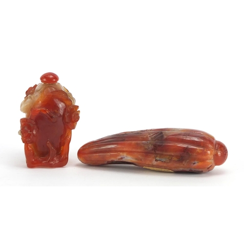 35 - Chinese carnelian snuff bottle carved with flowers and a carving of a fruit with inscribed paper lab... 