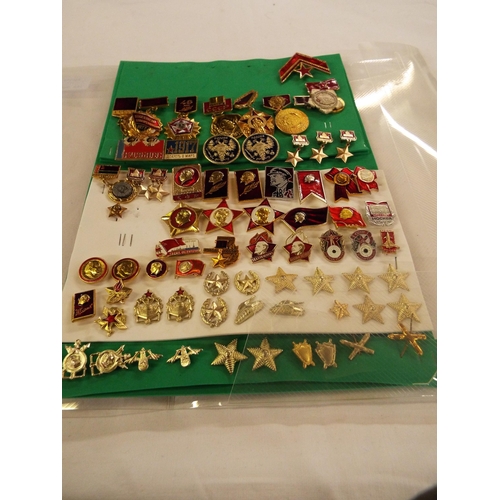117 - A folder of Russian medals, badges and insignia