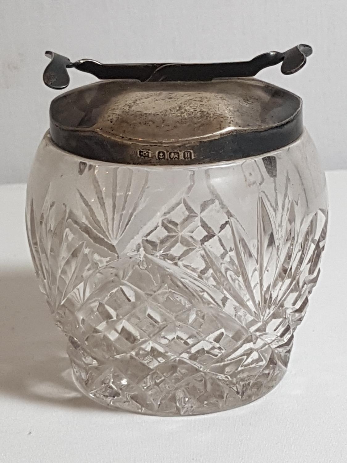 Cut glass sugar bowl with HM silver sugar tong lid. Approx 3.5"