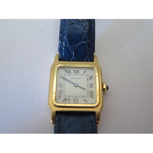232 - A Cartier Santos Ladies 18ct Gold Wristwatch, the 17mm dial with Roman numerals and manual movement,... 