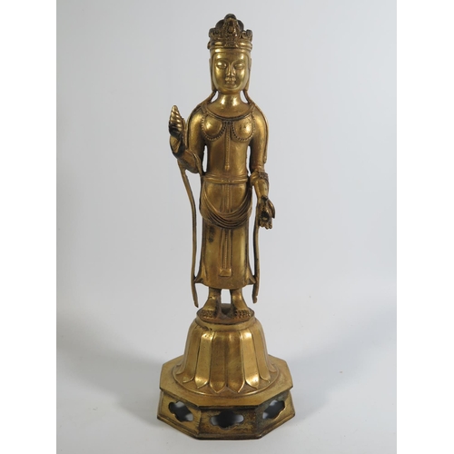 518 - A Chinese Gilt Bronze Figure of Buddha standing on a lotus flower, 30cm